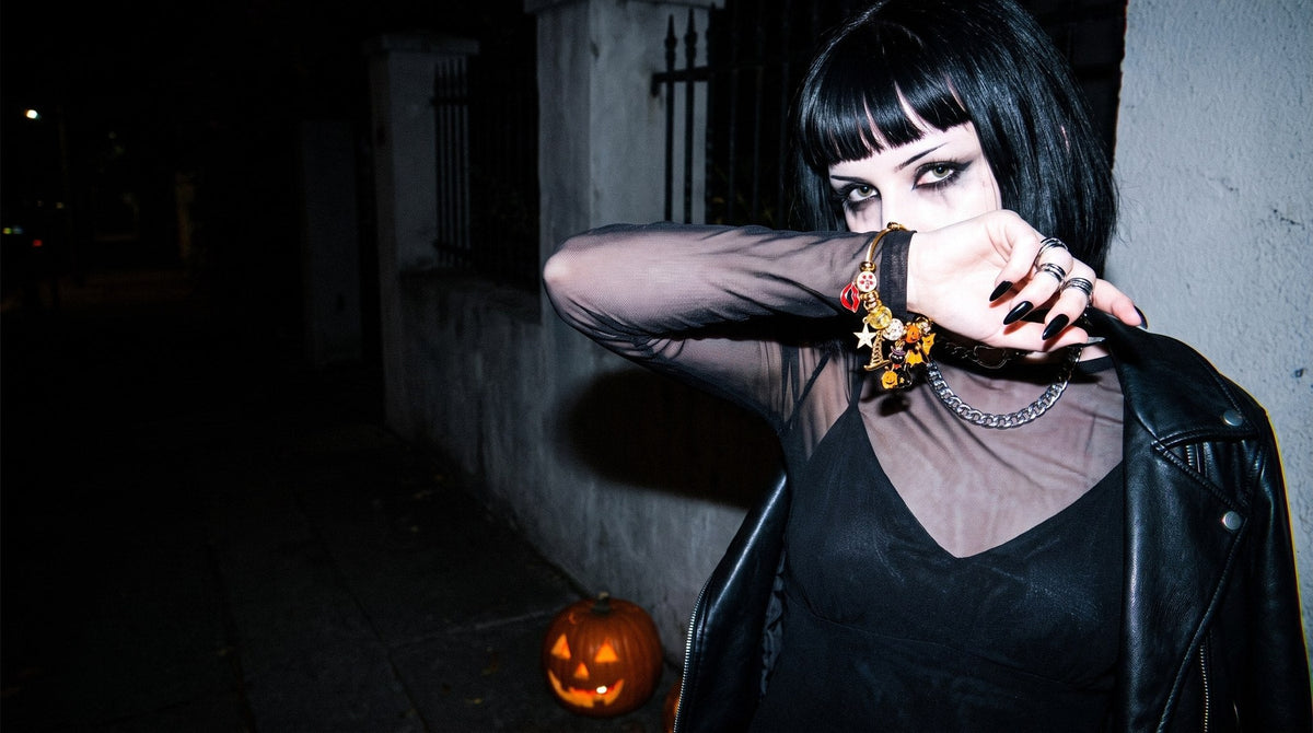 Halloween charm bangle worn on a dark street with a jack-o-lantern