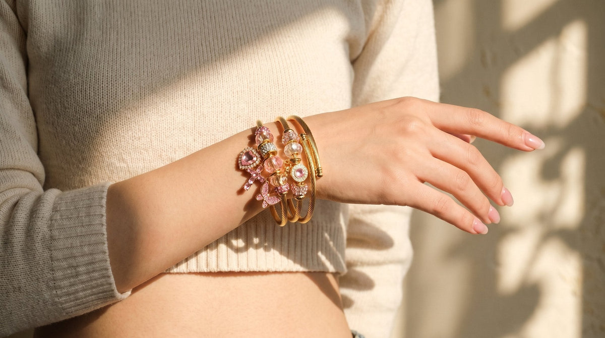 Three charm bangles stacked on one wrist